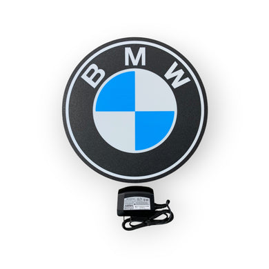 BMW led sign with a power adapter on a white background