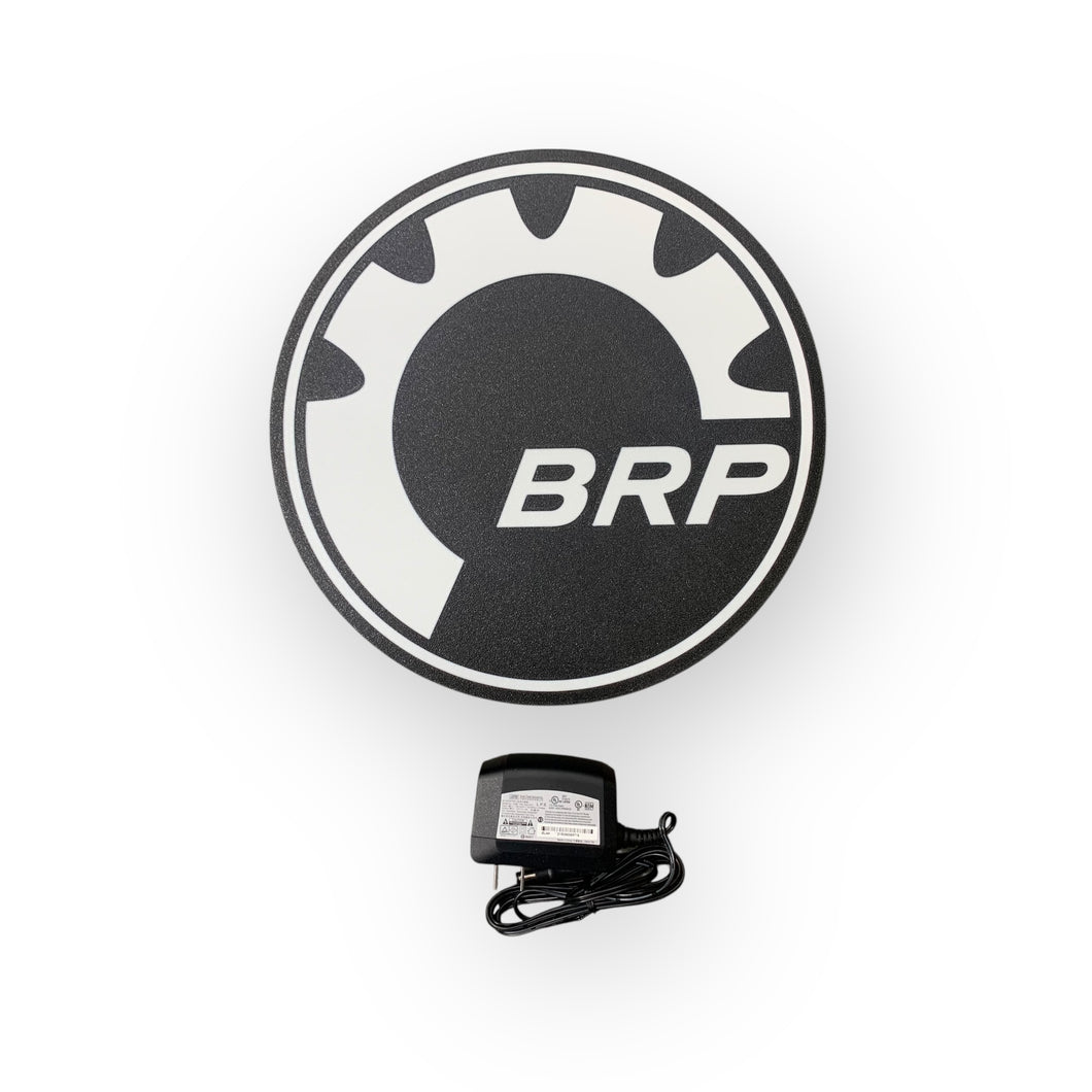 Round black and white logo with 'BRP' text on a white background on a led sign