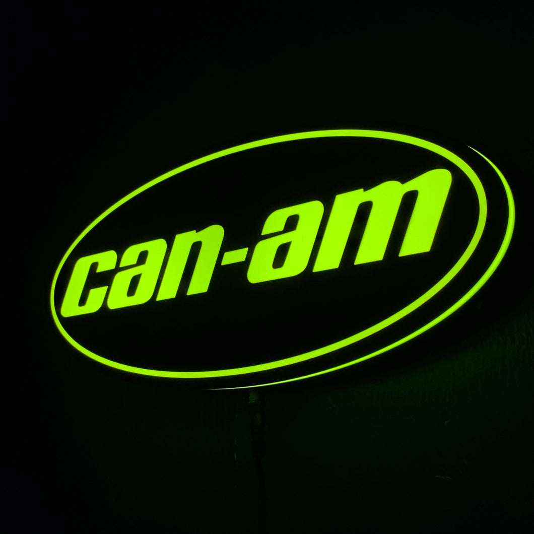 Can-Am led sign lit up in green on a black background