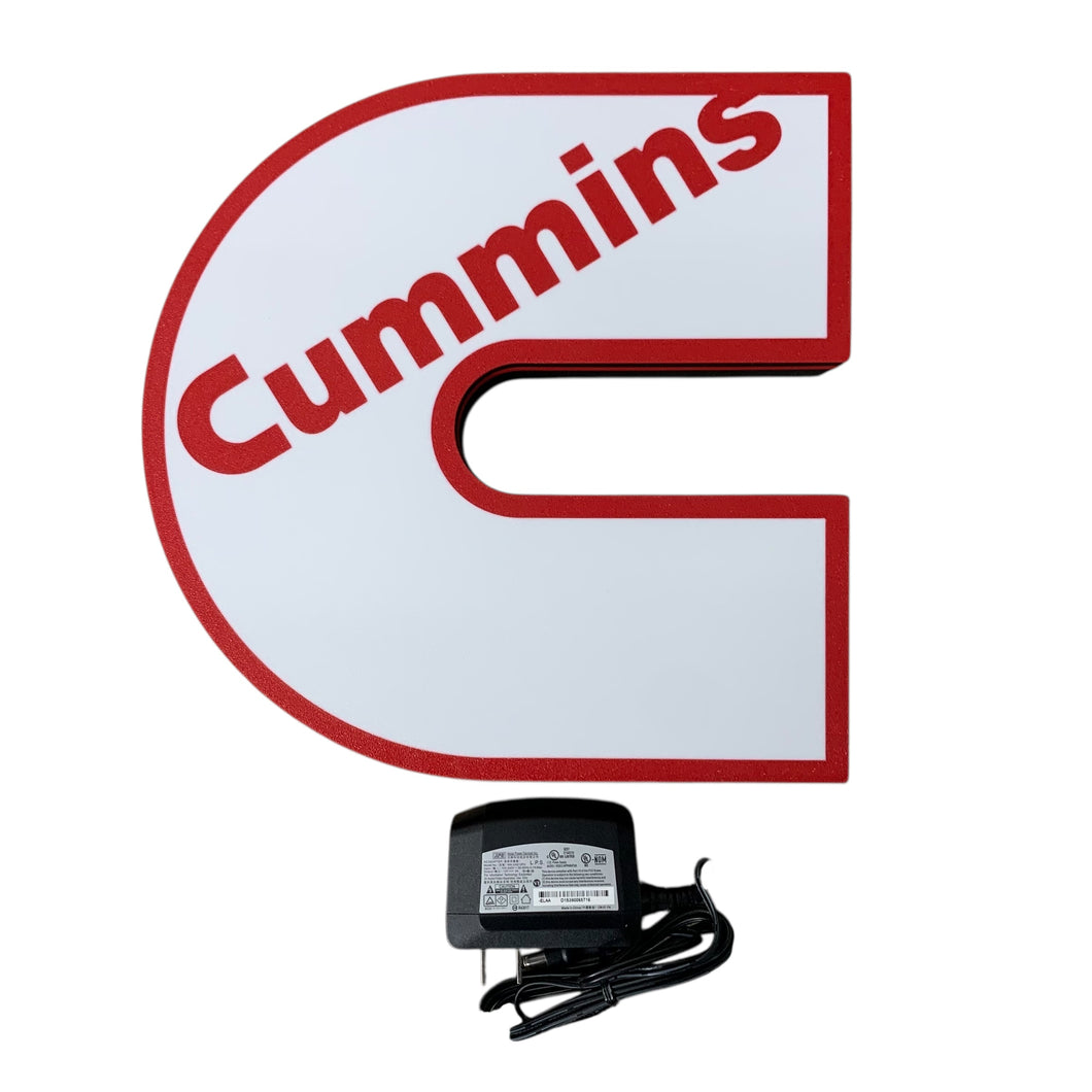 Cummins led sign with a power adapter on a white background
