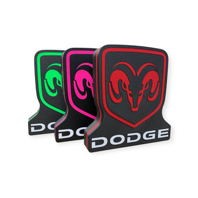 Three Dodge led signs in different colors on a white background