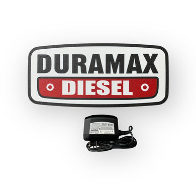 Duramax Diesel led sign with a power adapter on a white background