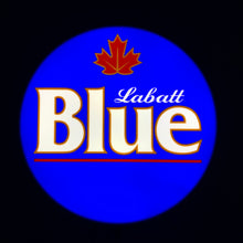 Load image into Gallery viewer, Labatt Blue logo with a red maple leaf on a blue background showing the front of a lit up LED indoor sign.