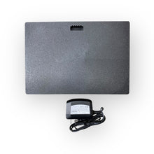 Load image into Gallery viewer, Black electronic device with power adapter on a white background