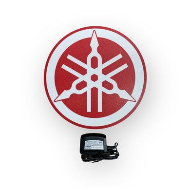 Yamaha led sign with a power adapter on a white background