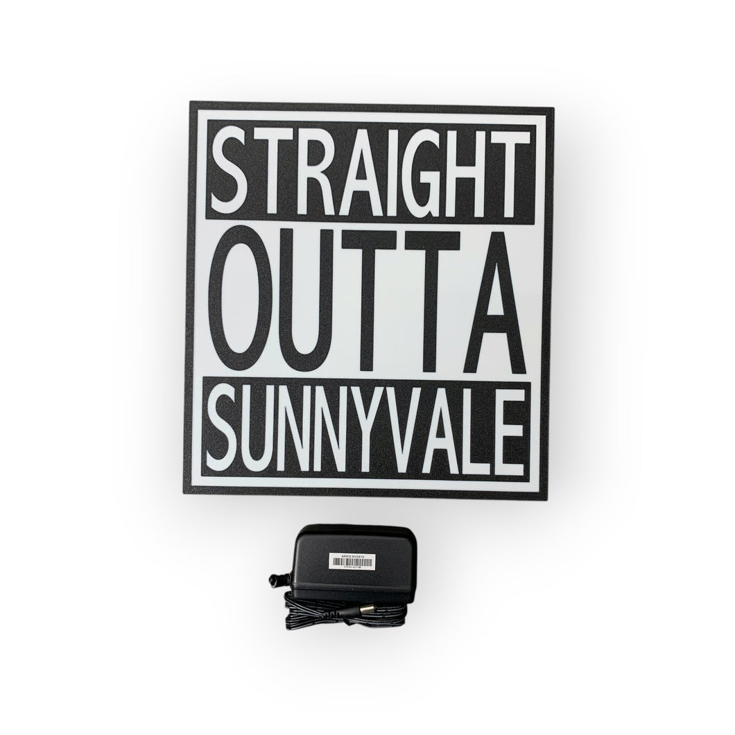 Decorative sign with 'Straight Outta Sunnyvale' text on a white background on a led sign, accompanied by a power adapter.