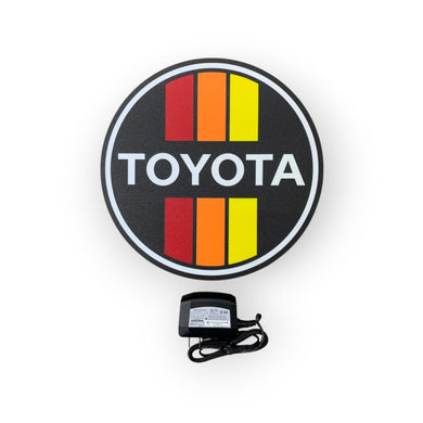 Toyota led sign with power adapter on a white background