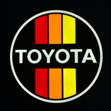 Load image into Gallery viewer, Toyota led sign lit up with red and yellow stripes on a black background