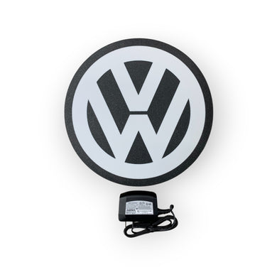Volkswagen led sign on a white background with a power adapter.
